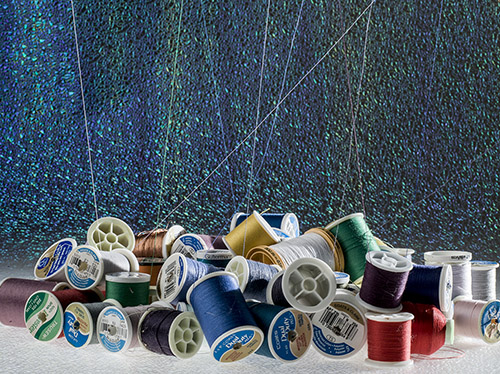 jumbled pile of thread spools in vibrant colors